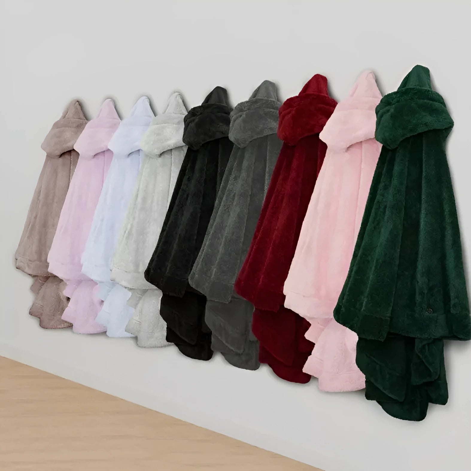 Thick pink hooded bathrobe with long sleeves and a cardigan front, shown on a hanger.