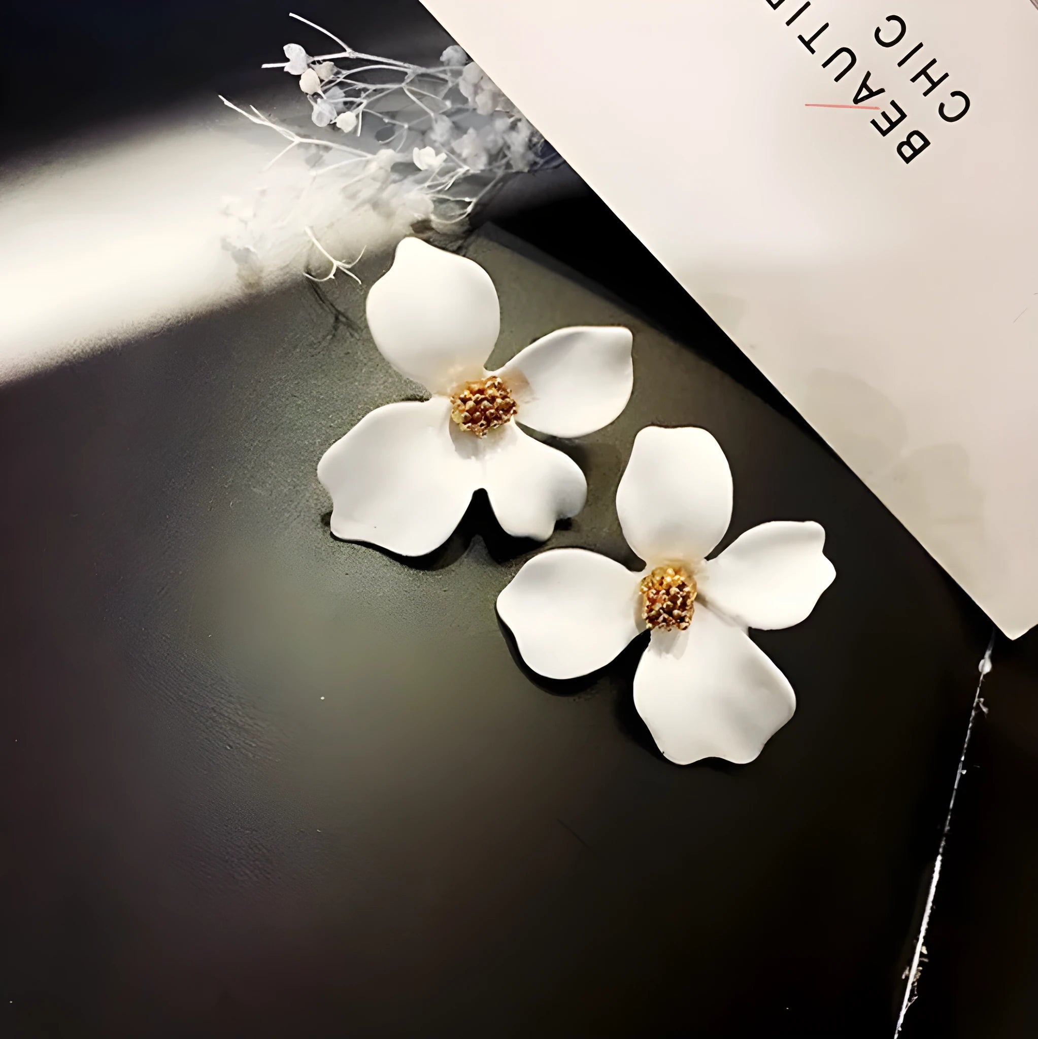 Flower shaped stud earrings in pink and white colours with electroplated alloy finish