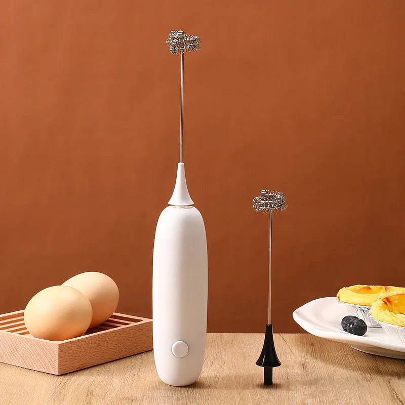 Hand-held electric milk frother blender in black or white colour for coffee preparation