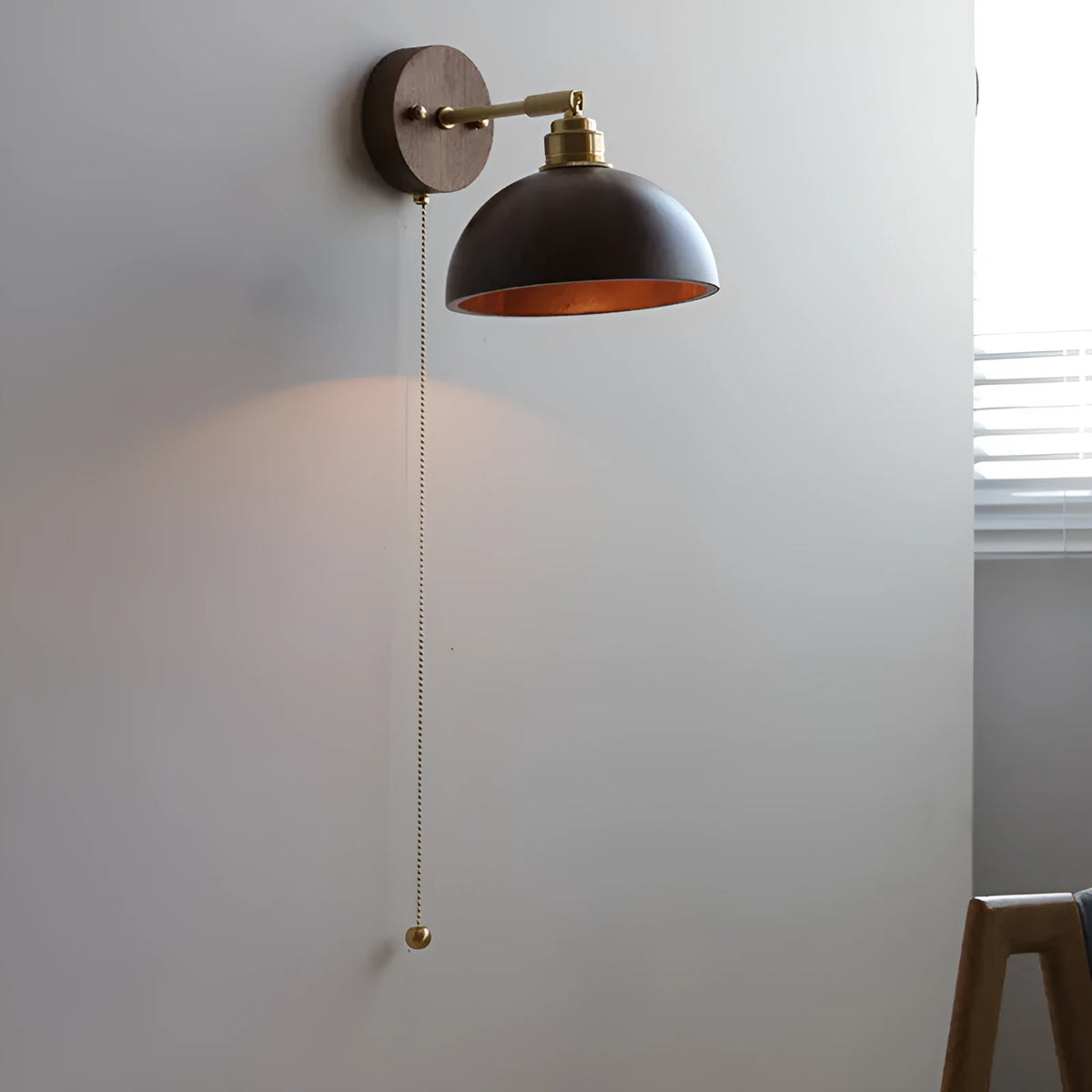 Inn Niche Nordic style wooden bedside wall lamp in walnut colour mounted on a light wall.