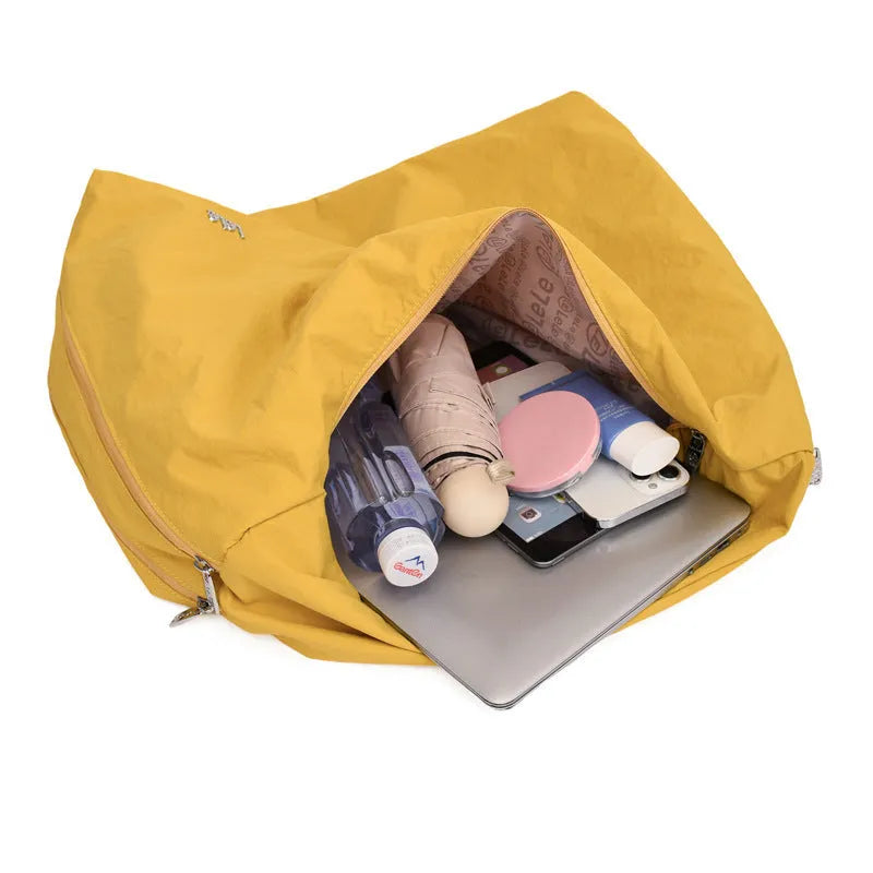 Soft nylon women's underarm bag in a heart shape, shown in black, blue, khaki, and yellow colours.