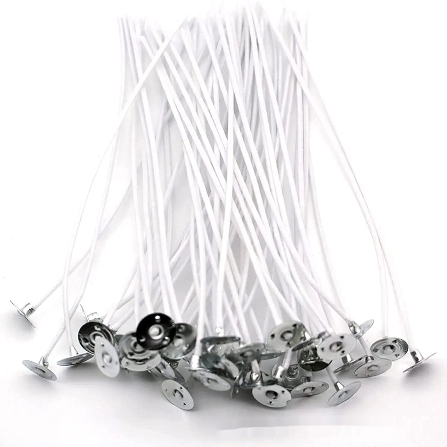 White cotton candle wicks in three lengths: 2.6cm, 6cm, and 8cm, laid out on a surface.