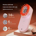 Pink and black smart massage comb with red light for scalp care, shown actual size under 10cm.