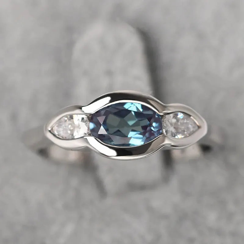 Geometric ellipse zircon ring in white gold colour showing structured design and stone inlay