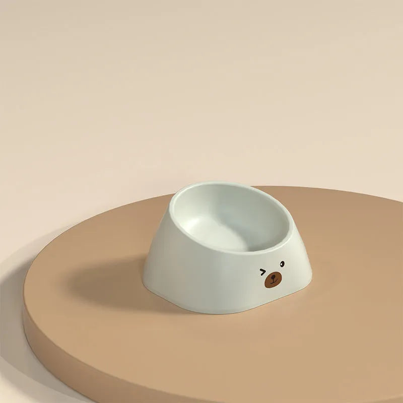 Green tilted stainless steel cat bowl with non-slip white base at a 15 degree angle
