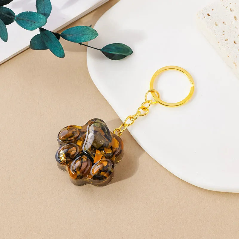 Small natural crystal cat's paw charm on a metal keyring loop.