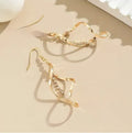 Gold colour female earrings with creative spiral design and geometric ellipse shape