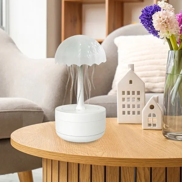 White jellyfish-shaped humidifier and essential oil diffuser with colourful night light on wooden desk