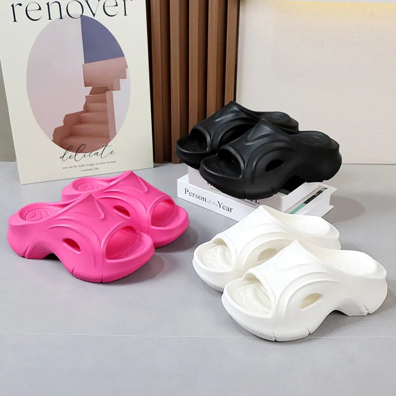 Women's white EVA slippers with thick sole and round toe on sandy beach