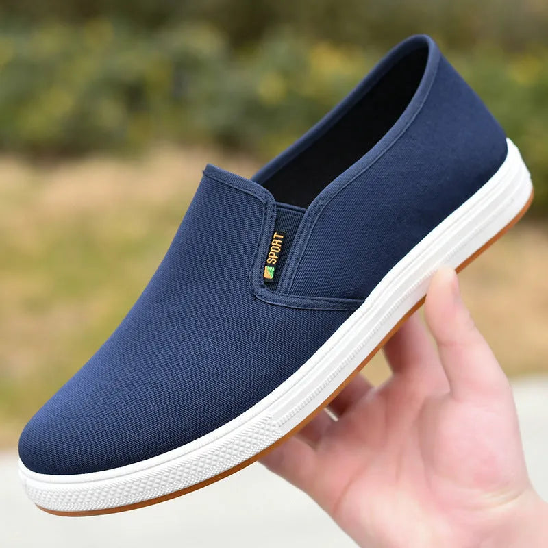 Men's black and blue canvas slip-on shoes with round toe and low-top design on composite sole
