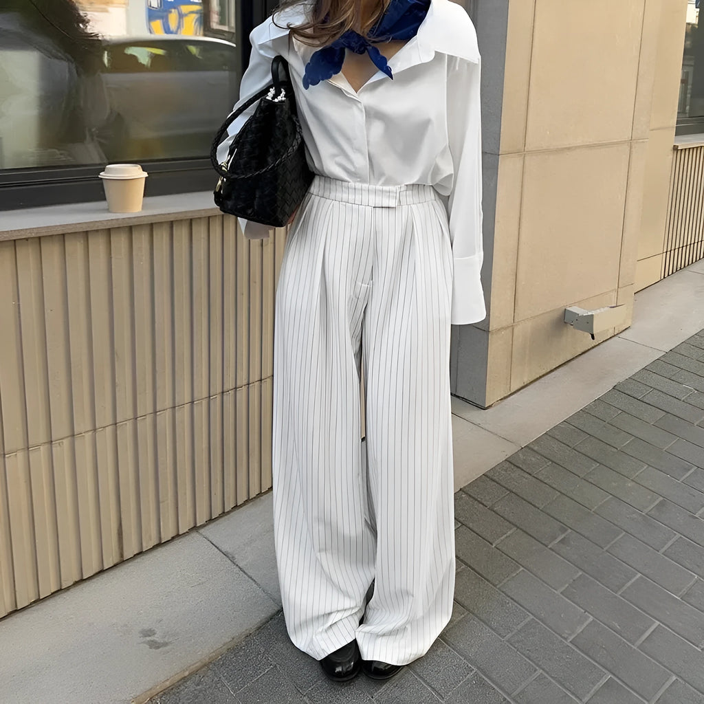 White striped wide-leg women's trousers with front zip fastening on hanger