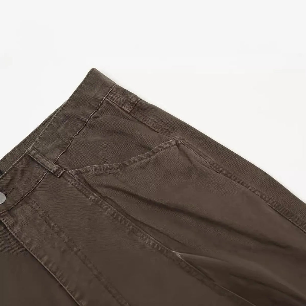 Men's brown straight-leg jeans with high waist and zip fly on mannequin