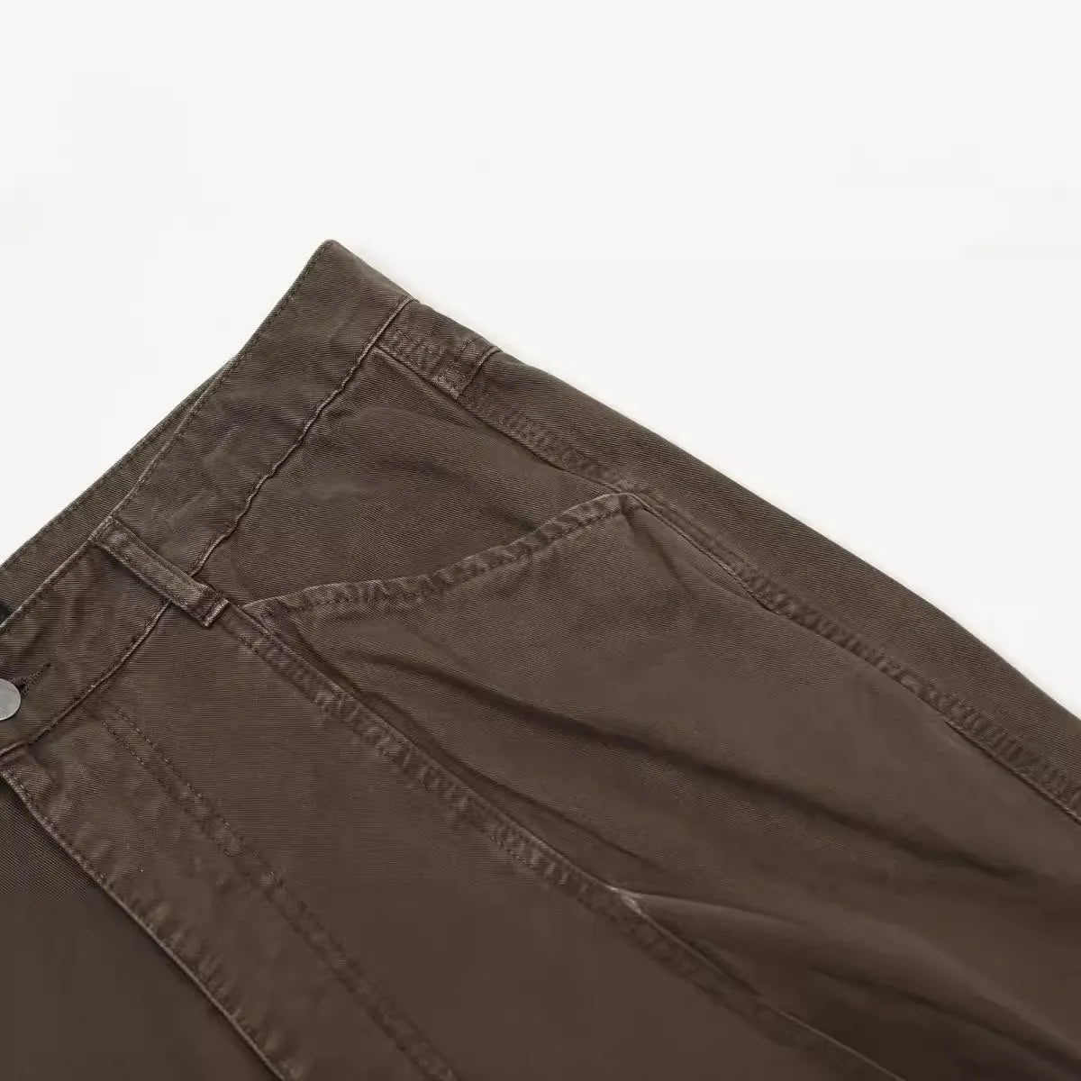 Men's brown straight-leg jeans with high waist and zip fly on mannequin