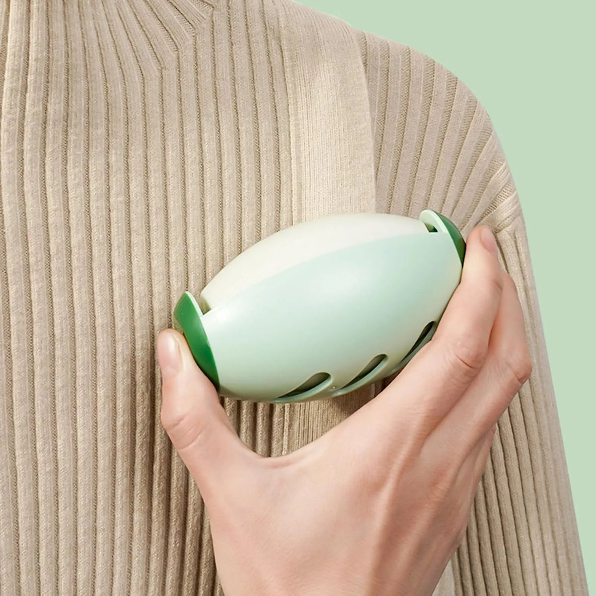 Green and white washable gel lint roller ball for pet hair removal from fabrics
