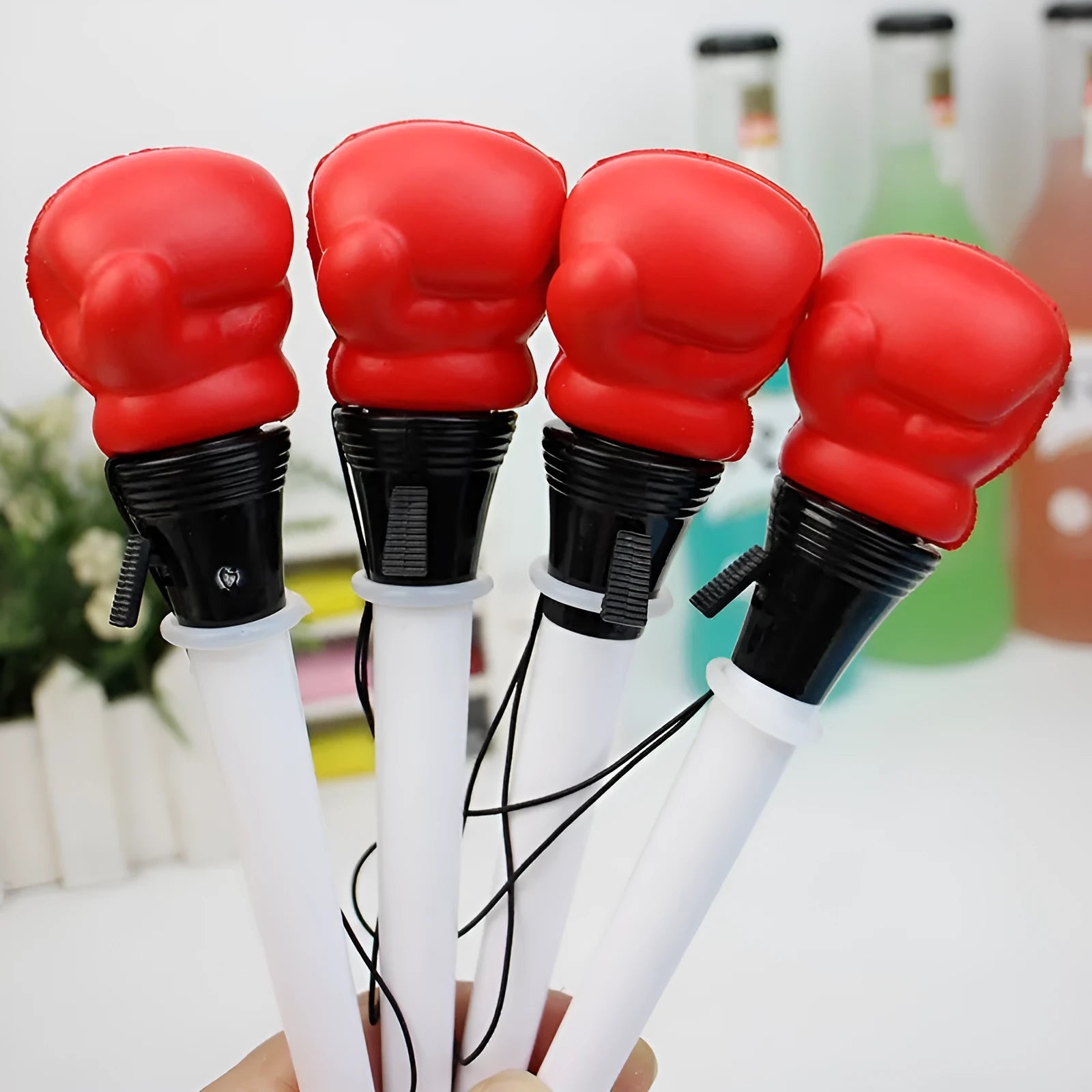 Set of four black boxing press ejection pens with bullet-shaped 0.7mm tips on a white surface.