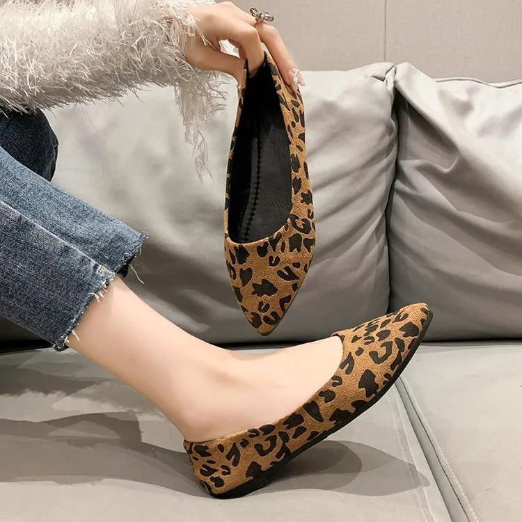 Women's leopard print flat pumps with a pointed toe and low flat heel on a rubber sole.