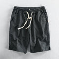 Men's striped cotton shorts in multiple colours showing loose straight cut and mid-waist design