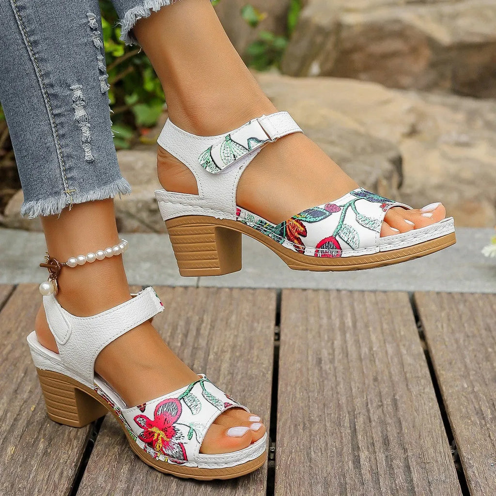 White women's high heel sandals with a velcro strap closure and rubber sole.
