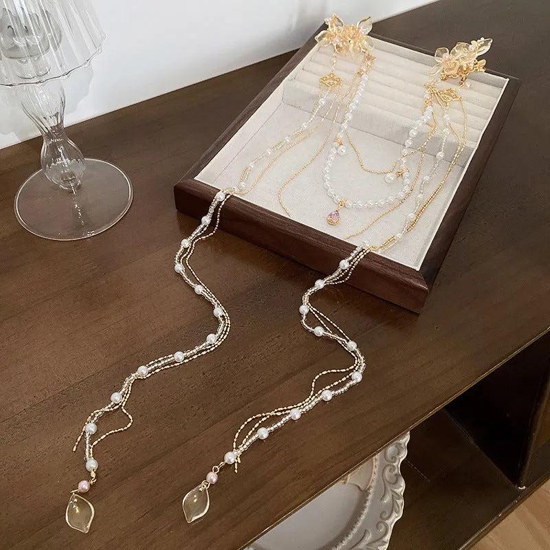 Women's pearl diamond flower hairpin with gold grip and long tassel decorative accessory