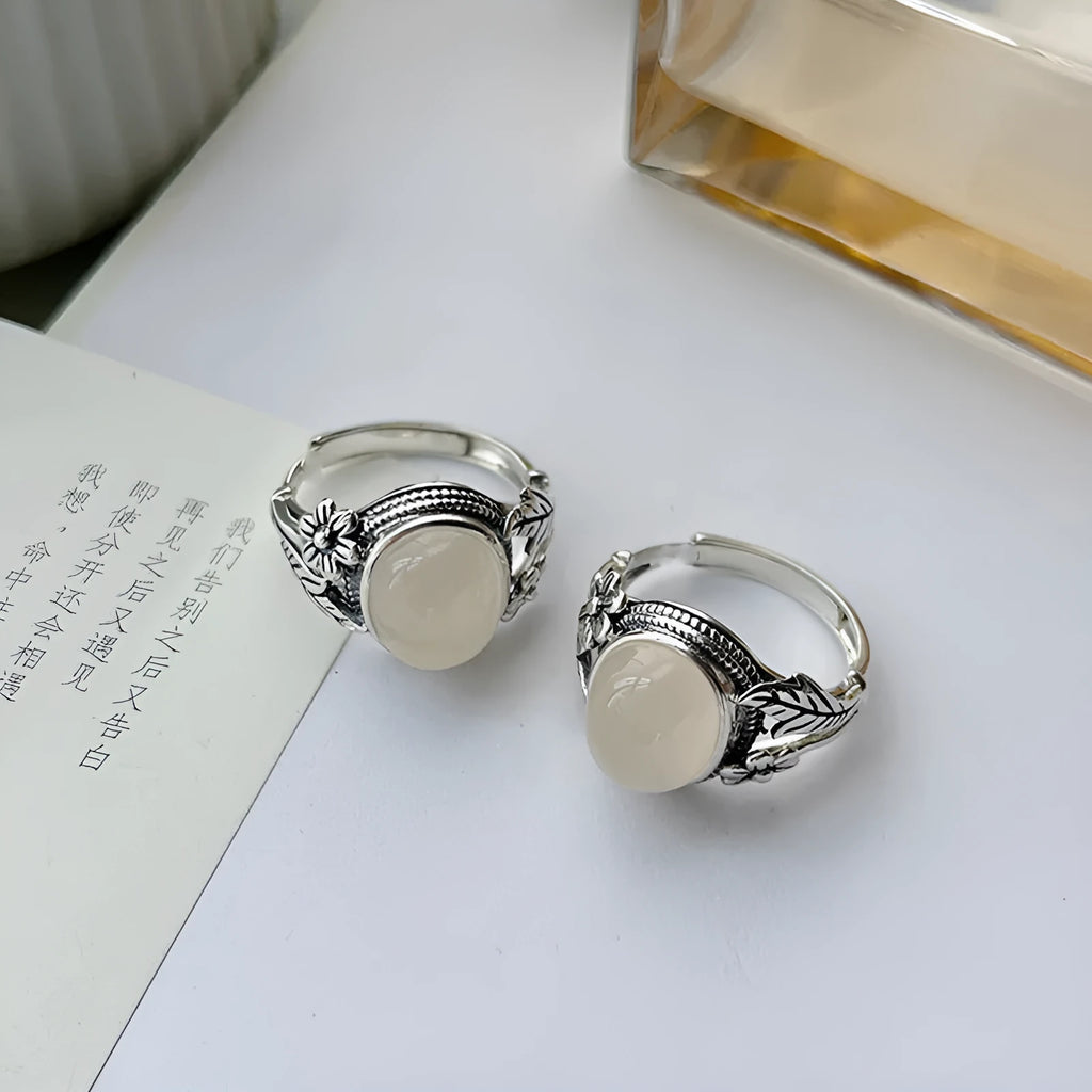 Adjustable vintage copper ring with a white imitation chalcedony stone on a U-shaped band.