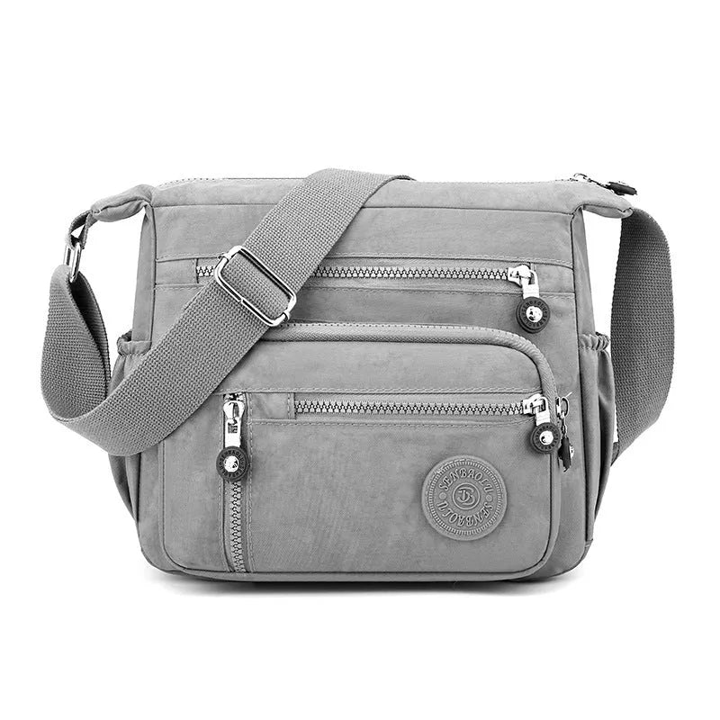 Nylon messenger bag with single shoulder strap in square vertical shape