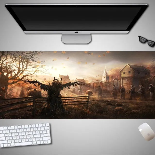 Oversized rectangular Halloween-themed mouse pad on a desk, showing one of 28 graphic designs.