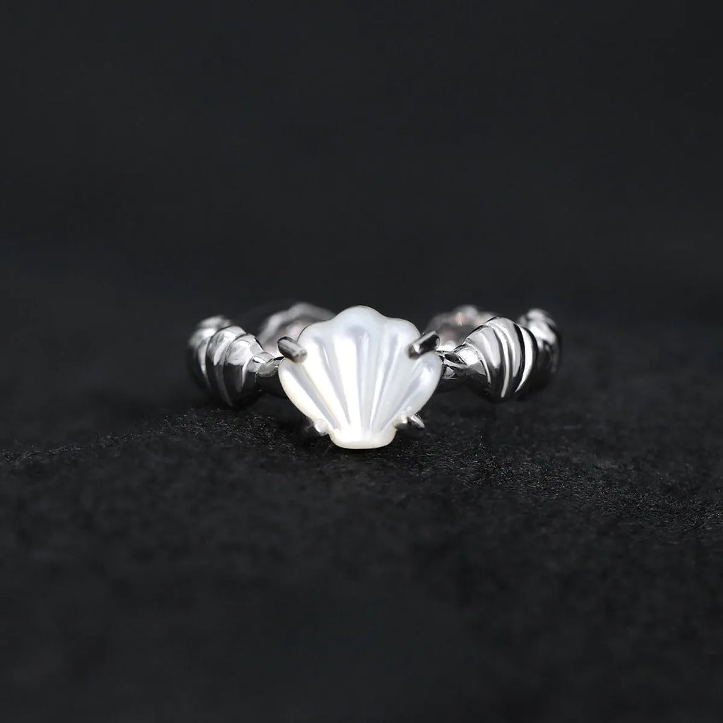Adjustable silver women's ring with shell design in shell white or tiger eye finish.