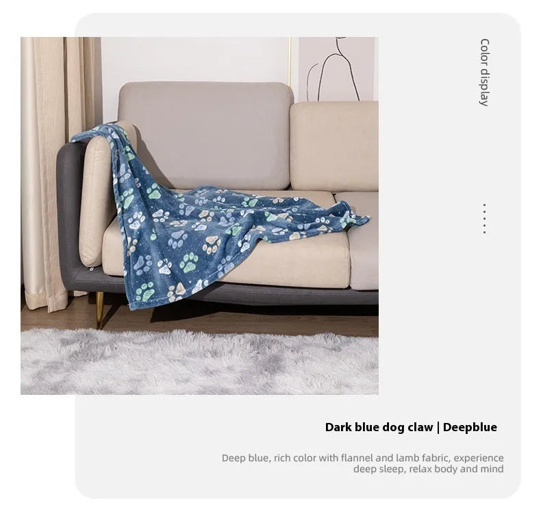 Blue cartoon dog pattern double-sided flannel pet blanket laid flat, showing its size next to a pet crate.