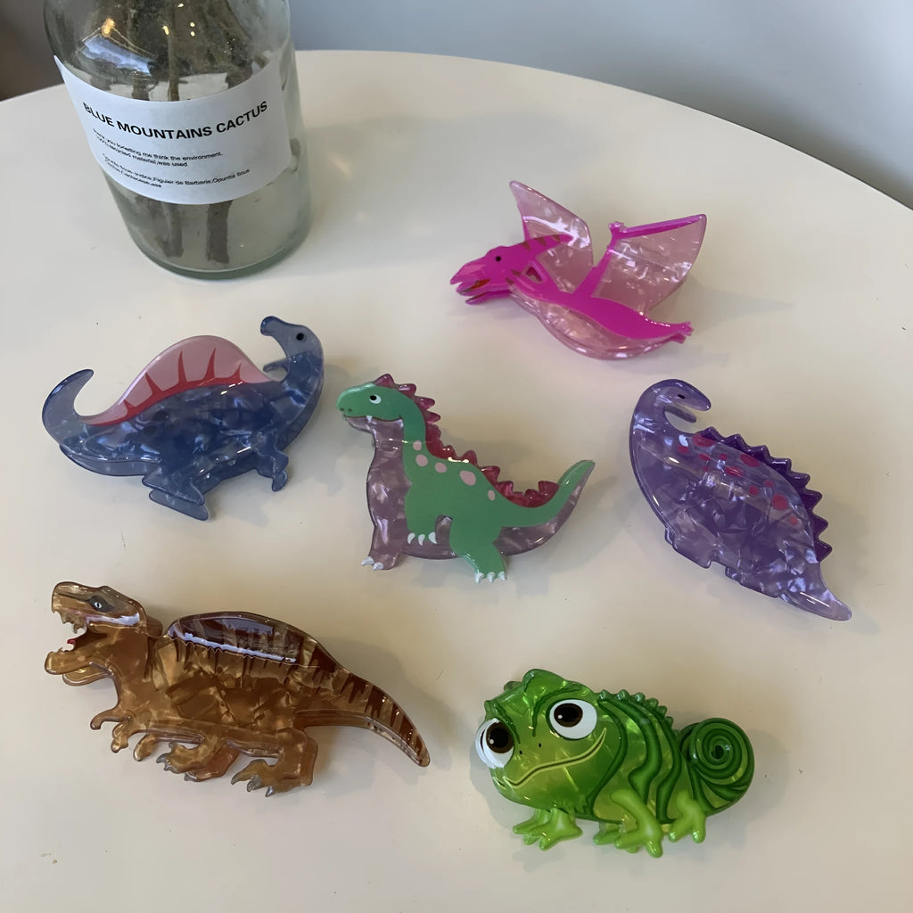 A dinosaur-themed acrylic jaw hair clip for women in one of six colours, showing a cute little dinosaur design.