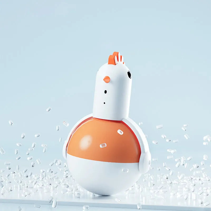Green and orange electric cat toy chicken with laser and sound features on a flat surface.