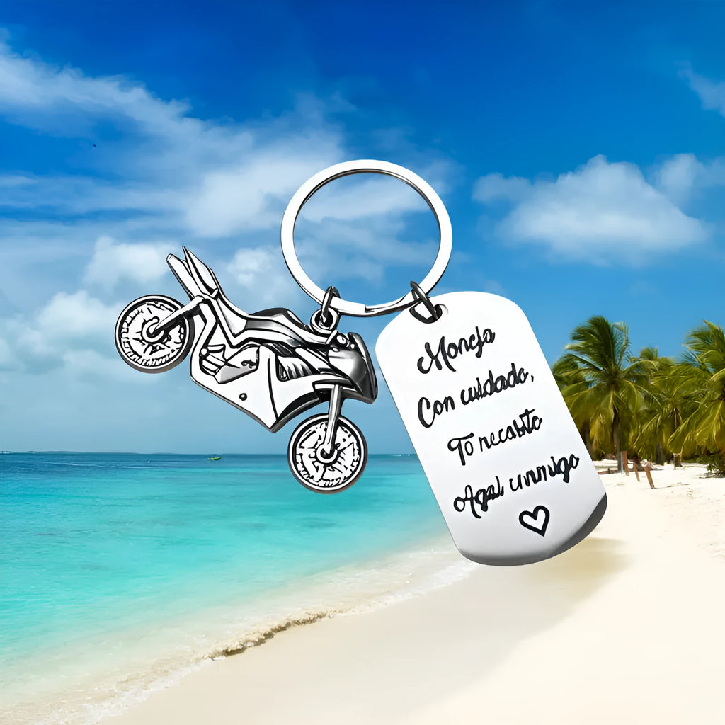 Stainless steel motorcycle key chain with modern design on velvet cloth.