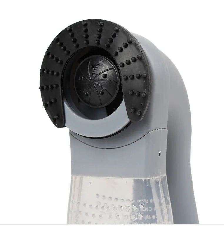 Grey handheld electric pet hair remover and massaging brush with soft rubber head.