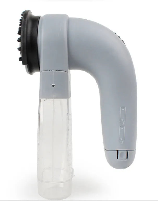 Grey handheld electric pet hair remover and massaging brush with soft rubber head.
