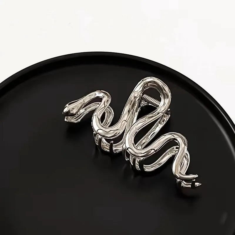 Silver metal hair barrette with a detailed Slytherin snake design, measuring 10.5 cm in length.