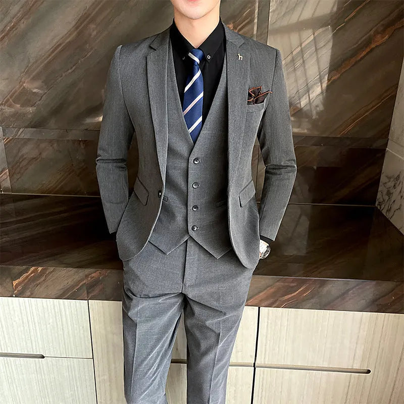Slim fit men's business suit in black or dark grey cotton blend fabric with adhesive interlining construction