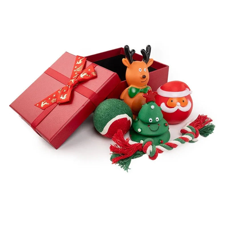 A set of red, green, and white vinyl Christmas dog toys including a Santa head, bite rope, and tennis ball.