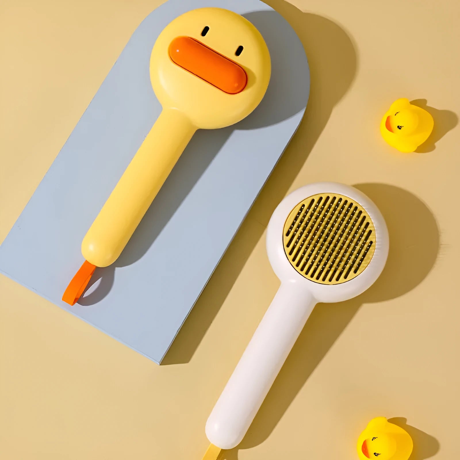 Small yellow duck comb brush for pet hair removal with open-section needle teeth
