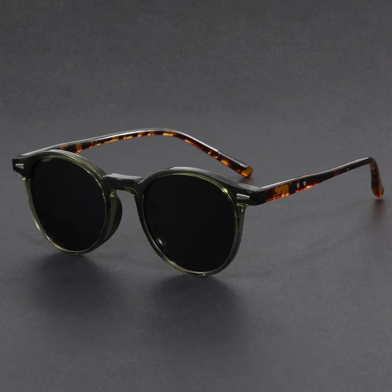 Retro round frame sunglasses with polarised grey lenses on a neutral background.