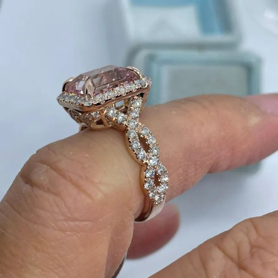 Geometric-shaped alloy ring with a rose gold electroplated finish on a neutral background.