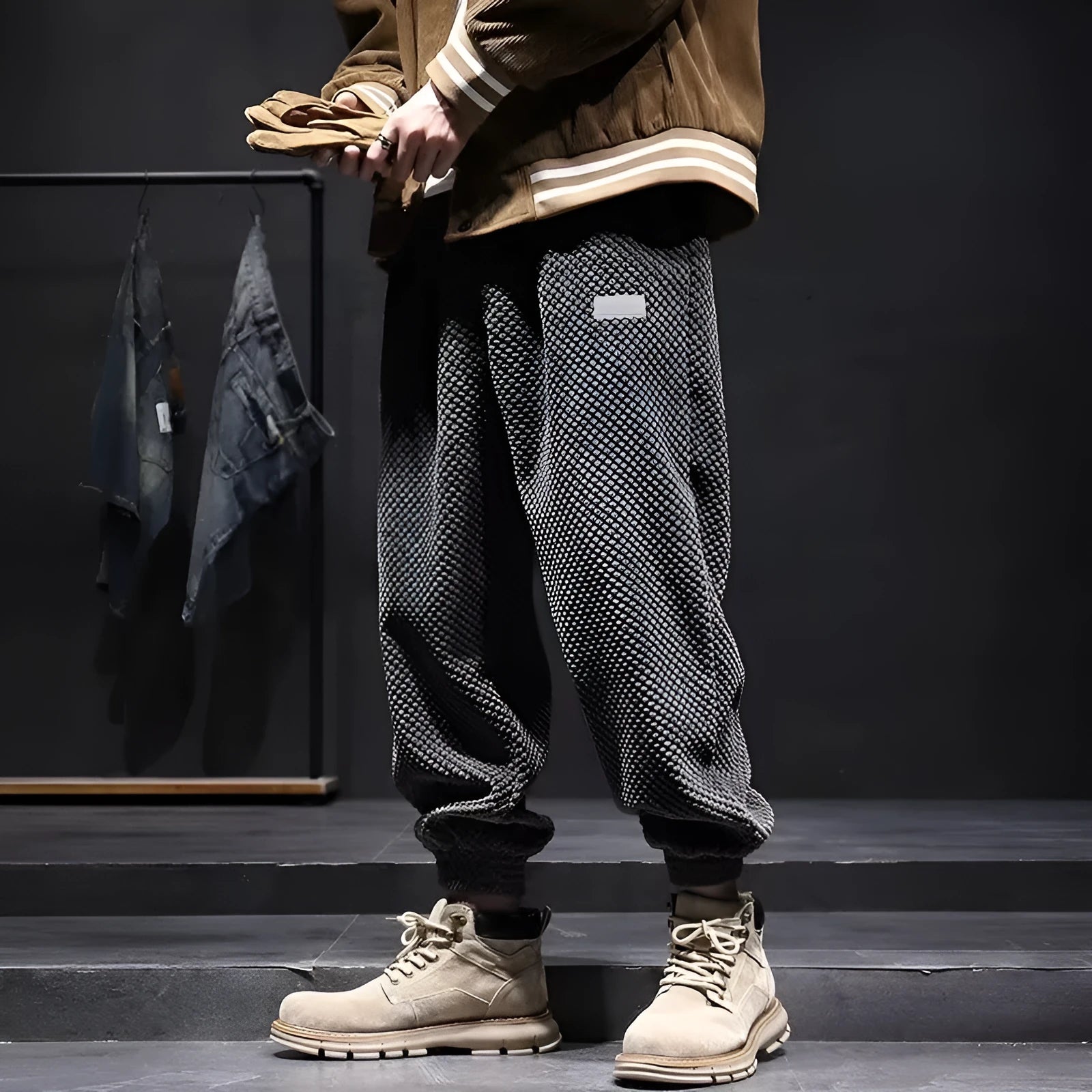 Man wearing grey straight-leg casual sweatpants with an ankle-tied design detail.