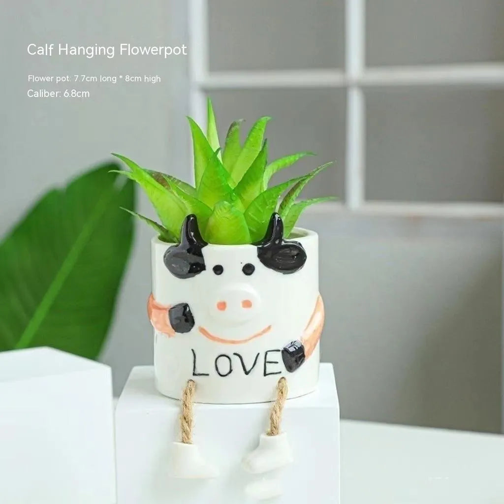 Ceramic hanging foot flowerpot for succulent plants in cartoon design on desktop