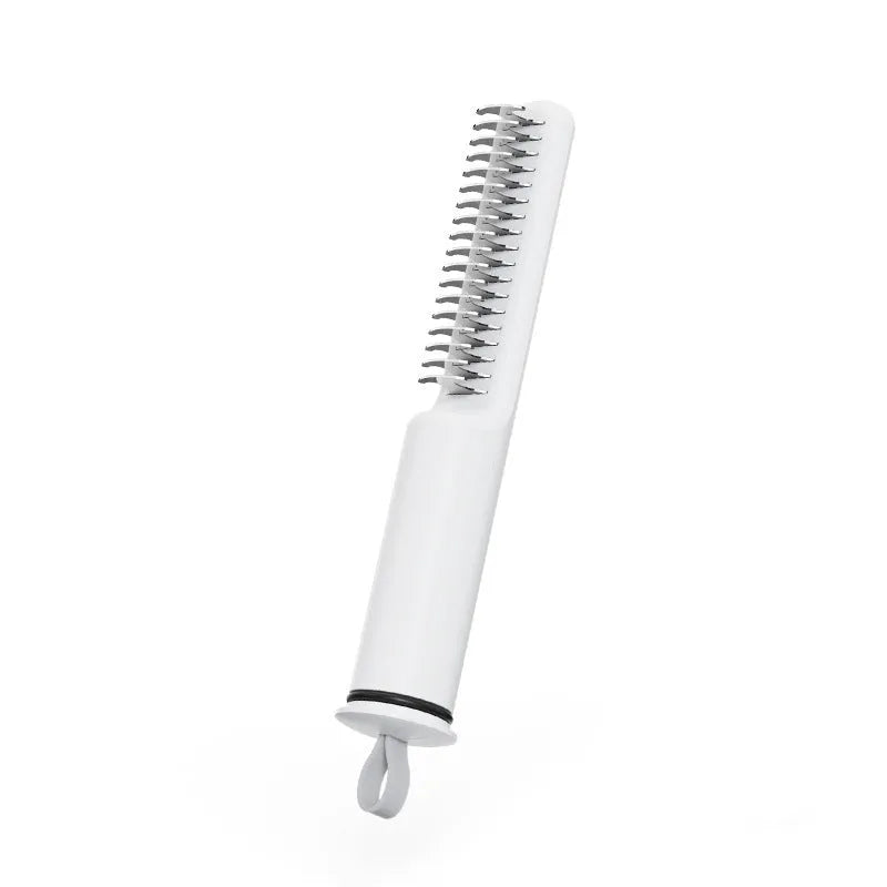 Stainless steel pet dematting comb with user-friendly handle on a pink background.