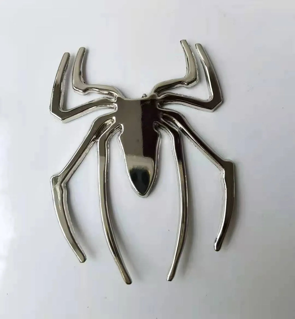 Three-dimensional metal spider car sticker in gold, silver, black, or red.