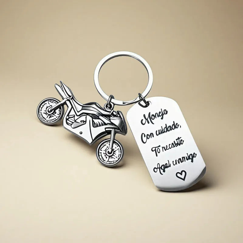 Stainless steel motorcycle key chain with modern design on velvet cloth.