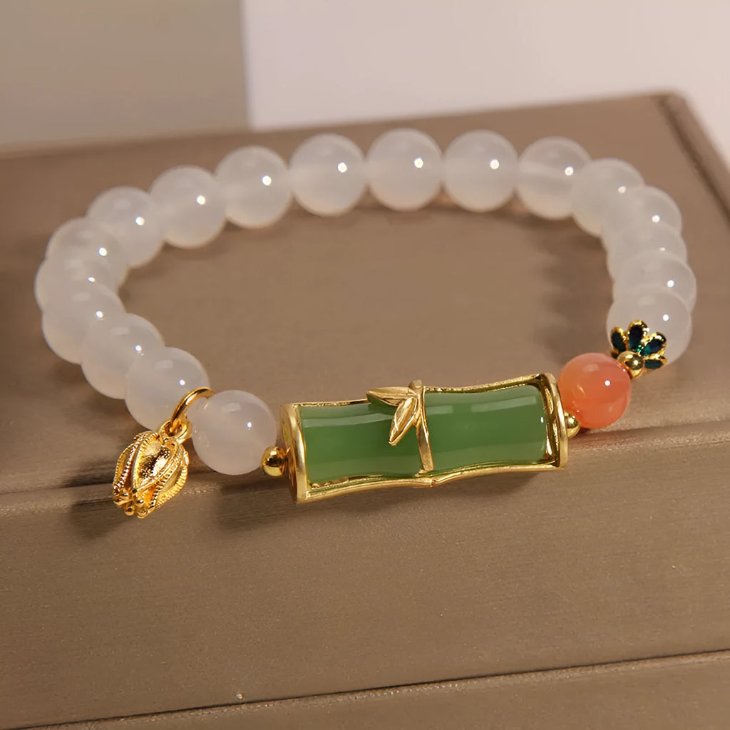 Women's Chinese style beaded bracelet with white agate centre, jade beads, and bamboo joint design.