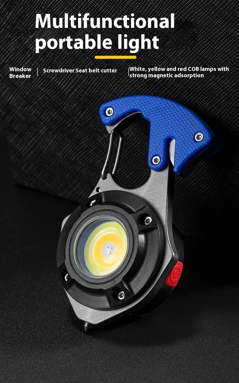 Compact silver and black multifunctional keychain flashlight with keyring, COB LED panel, and window breaker tool.