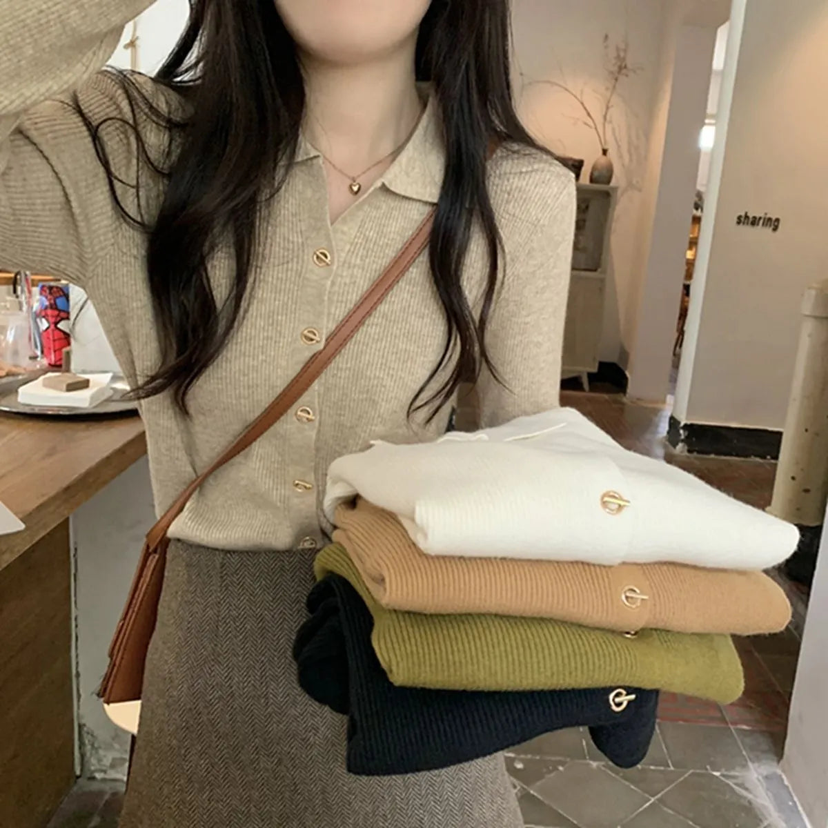Long-sleeve viscose knit cardigan in loose fit, shown in beige colour on hanger.