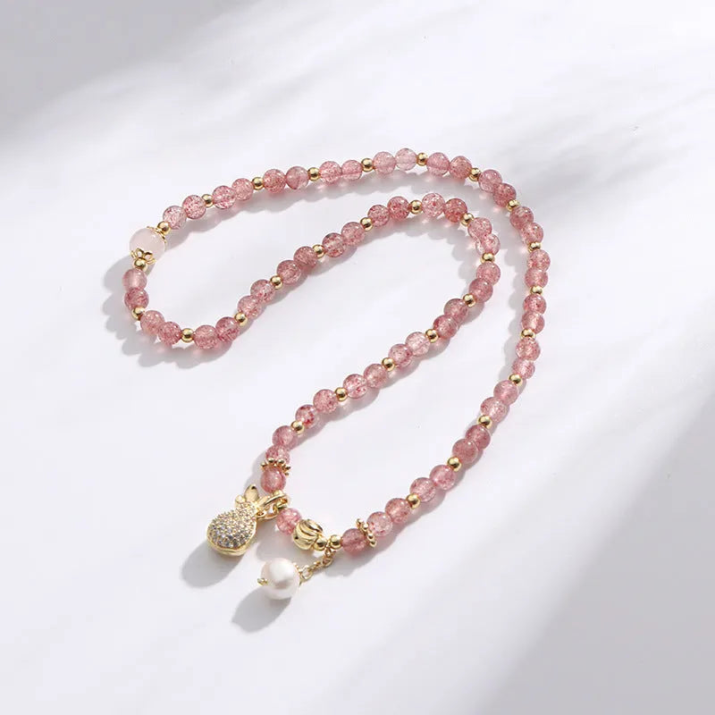 Women's strawberry quartz crystal bracelet with geometric design on wrist