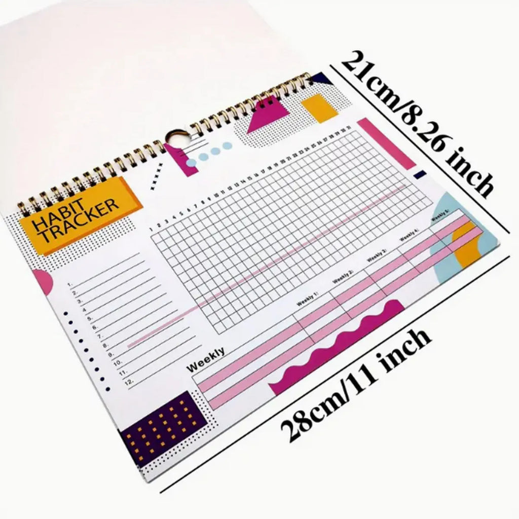 Habit tracking journal notebook open showing planning pages with colour options