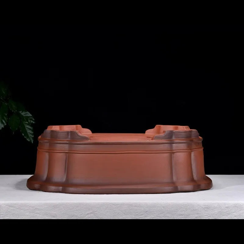Large oval antique-finish purple clay flowerpot with carved crabapple tree design.